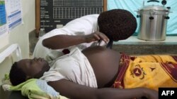 FILE - A pregnant woman in Uganda, September 27, 2011.