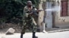 A soldier fires an AK-47 rifle during a protest against President Pierre Nkurunziza and his bid for a third term, in Bujumbura, Burundi, May 25, 2015.