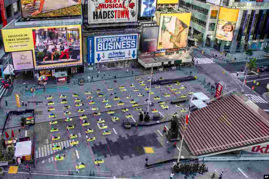Overhead view of yogis participating in Solstice in Times Square: Mind Over Madness Yoga – an annual all-day outdoor yoga event in New York.