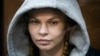 Anastasia Vashukevich, also known on social media as Nastya Rybka, sits in a cage in the court room in Moscow, Russia, Jan. 19, 2019.