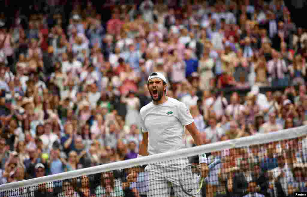 Italy's Matteo Berrettini celebrates after defeating Poland's Hubert Hurkacz during the men's singles semifinals match of the Wimbledon Tennis Championships in London.