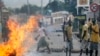 Protester stand by a burning barricade in the Musaga neighborhood of Bujumbura, Burundi, May 21, 2015.