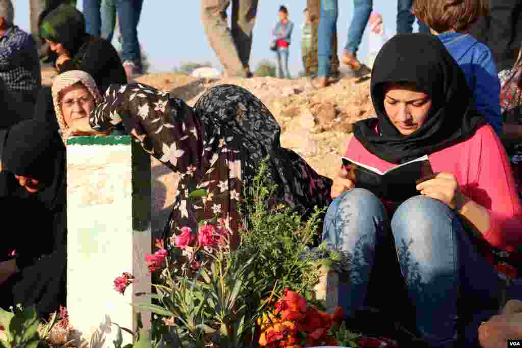 Displaced Afrin people visit the graves of their beloved ones in the eid
