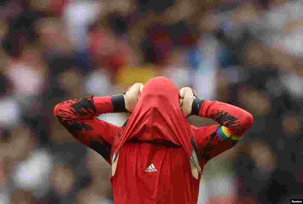 Germany's Manuel Neuer reacts after England's Raheem Sterling scored their first goal during the Euro 2020 soccer match round of 16 at Wembley Stadium, London, Britain.