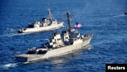 The guided-missile destroyer USS Barry (DDG 52), (front) pulls into formation with French Marine Nationale anti-submarine frigate Jean de Vienne (D 643) during Exercise Proud Manta 2013 (POMA 13) in this Feb. 26, 2013 U.S. Navy handout photo. 