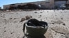 FILE - A helmet belonging to an Islamic State militant is seen on the ground in the town of al-Melabiyyah, south of Hasaka city, Syria, Nov. 24, 2015.