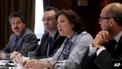 Najib Ghadbian, far left, with Bassma Kodmani, center, hold news conference of Syrian National Council members, New York, July 17, 2012.