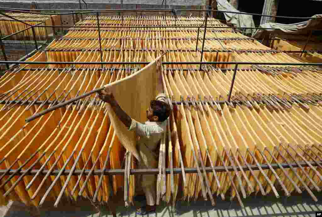 A vendor arranges traditional vermicelli noodles, a favorite during the Muslim's holy fasting month of Ramadan at a factory, in Lahore, Pakistan.