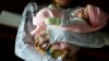 En esta foto de archivo del 14 de mayo de 2015, una niña de 13 años sostiene a su bebé de un mes en un albergue para niños con problemas en Ciudad del Este, Paraguay.