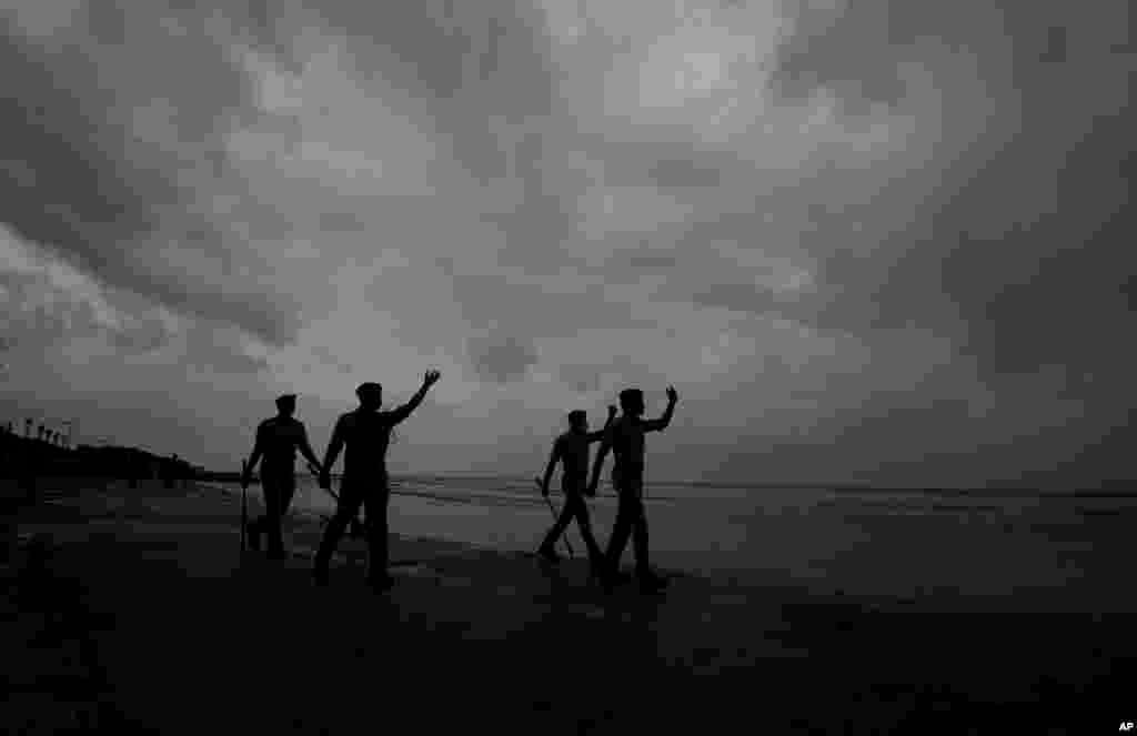 Policemen ask people to move to cyclone shelters as they patrol a beach in Balasore district in Odisha, India. Tens of thousands of people were evacuated in low-lying areas of two Indian states to escape from a powerful storm barreling toward the eastern coast. 
