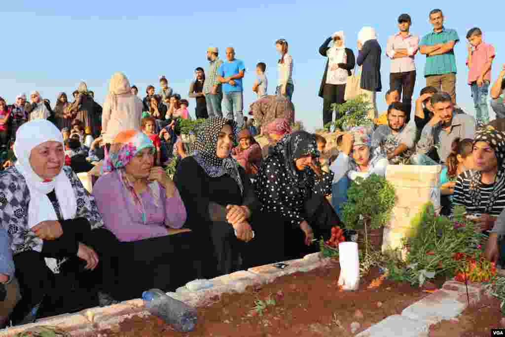 Displaced Afrin people visit the graves of their beloved ones in the eid