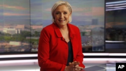 Former French presidential election candidate for the far-right Front National party Marine Le Pen poses prior to an interview on the evening news broadcast of French TV channel TF1, May 18, 2017, in Boulogne-Billancourt, near Paris. 