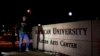 FILE - Students walk through the American University campus in Washington, Dec. 11, 2013.