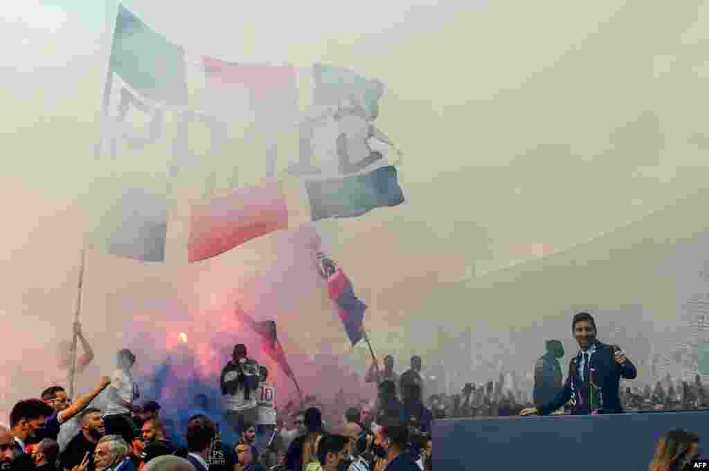 Paris Saint-Germain's Argentinian forward Lionel Messi salutes supporters gathered outside the Parc des Princes stadium after his first official press conference as PSG player in Paris, France.