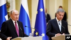 Russian President Vladimir Putin (L) and Finland's President Sauli Niinisto are seen at their joint press conference in the Presidential Palace in Helsinki, Finland, Aug. 21, 2019. Putin is on an official visit to Finland.