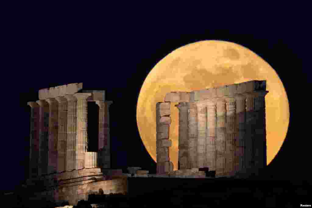 The full moon, known as the "Super Flower Moon" rises over the Temple of Poseidon in Cape Sounion, near Athens, Greece, May 26, 2021.