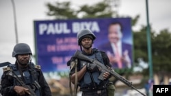 FILE - Members of the Cameroonian gendarmerie patrol in the Omar Bongo Square of Cameroon's majority anglophone South West province capital, Buea.