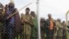 Congolese M23 rebel fighters gather inside an enclosure after surrendering to Uganda's government at Rugwerero village in Kisoro district, 489km (293 miles) west from Uganda capital Kampala, Nov. 8, 2013. 