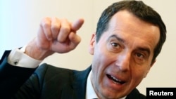 FILE - Austrian railways corporation Osterreichische Bundesbahnen (OeBB) CEO Christian Kern addresses a news conference in Vienna, Jan. 31, 2014. Kern will be formally chosen as chancellor next week.