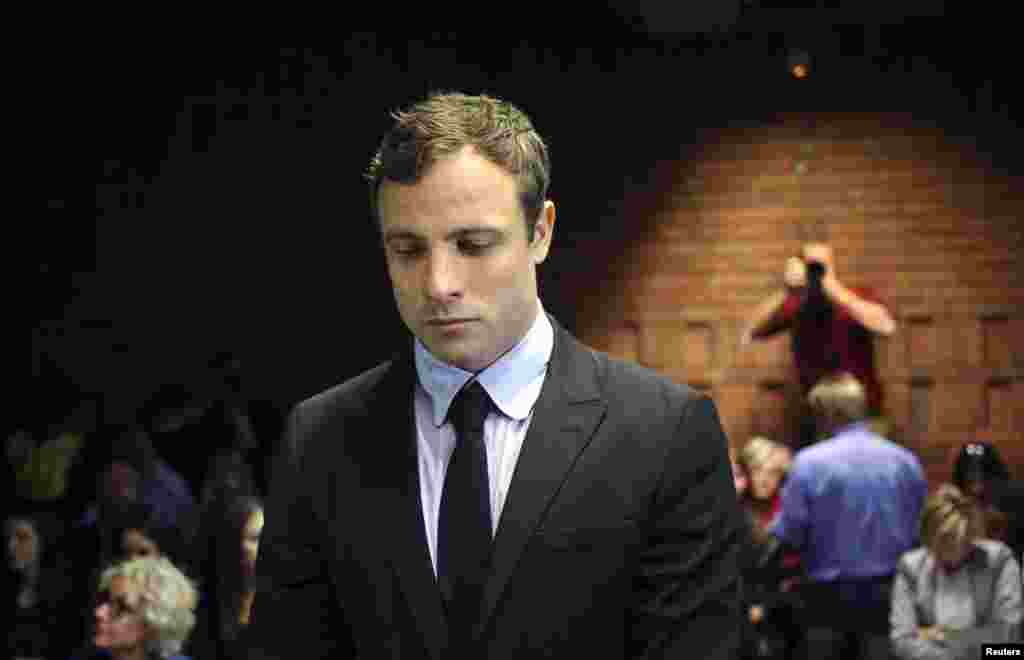 Olympic and Paralympic running star Oscar Pistorius stands during court proceedings at the Pretoria Magistrates court, August 19, 2013.